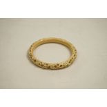 Ivory bangle, circa 1935, carved with an Asian dragon, internal diameter 6.