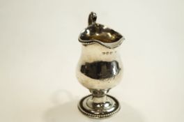 A George III silver pear-shaped pedestal milk jug, with a scroll handle,