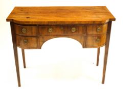 An early 19th Century mahogany bow fronted sideboard with five drawers and tapered square section