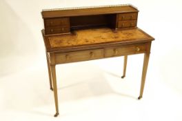 An Edwardian Hepplewhite revival inlaid mahogany leather top writing desk with tilted upstand,