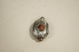 A pill box locket, set with agates, the interior gilded, with indistinct marks, 5.