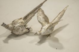 A pair of silver pheasant cock and hen table ornaments by C J Vander Ltd, London 1990, 24cms and 22.