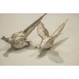 A pair of silver pheasant cock and hen table ornaments by C J Vander Ltd, London 1990, 24cms and 22.