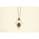 An opal triplet set pendant on a chain, the two stones set within an open lozenge frame, 6.