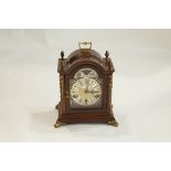 A 20th Century mahogany bracket clock with gilt metal mount and acorn finials,