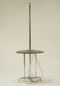 A mid 20th century chrome standard lamp, extending down to a mirrored table, on four foot base,
