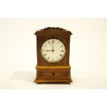 A walnut cased mantel clock, with brass carry handle and bun feet,