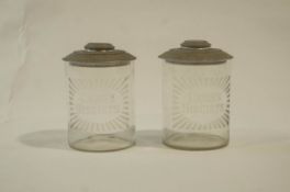 A pair of early 20th Century glass advertising biscuit barrels for Carr's biscuits.