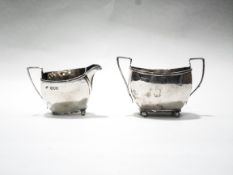 A late Victorian silver oblong cream jug and matching sugar, with angular handles,