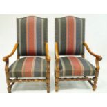 A pair of elbow chairs with upholstered backs and seats with walnut arms and legs.