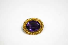 A Victorian oval amethyst brooch with a leaf carved border, 10.