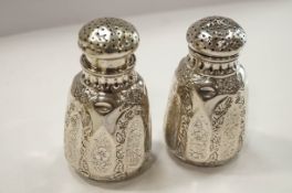 A pair of Continental white metal peppers, apparently unmarked,