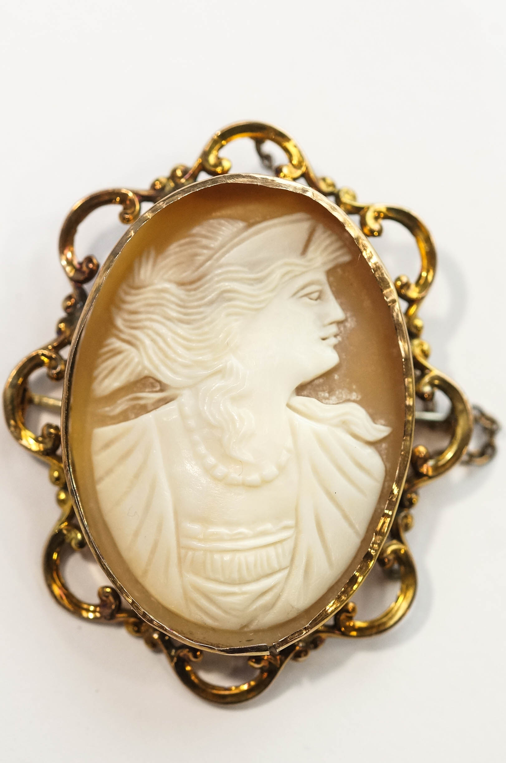 A late Victorian shell cameo brooch, the female profile in a C scroll edge mount stamped '9c', 5. - Image 2 of 2