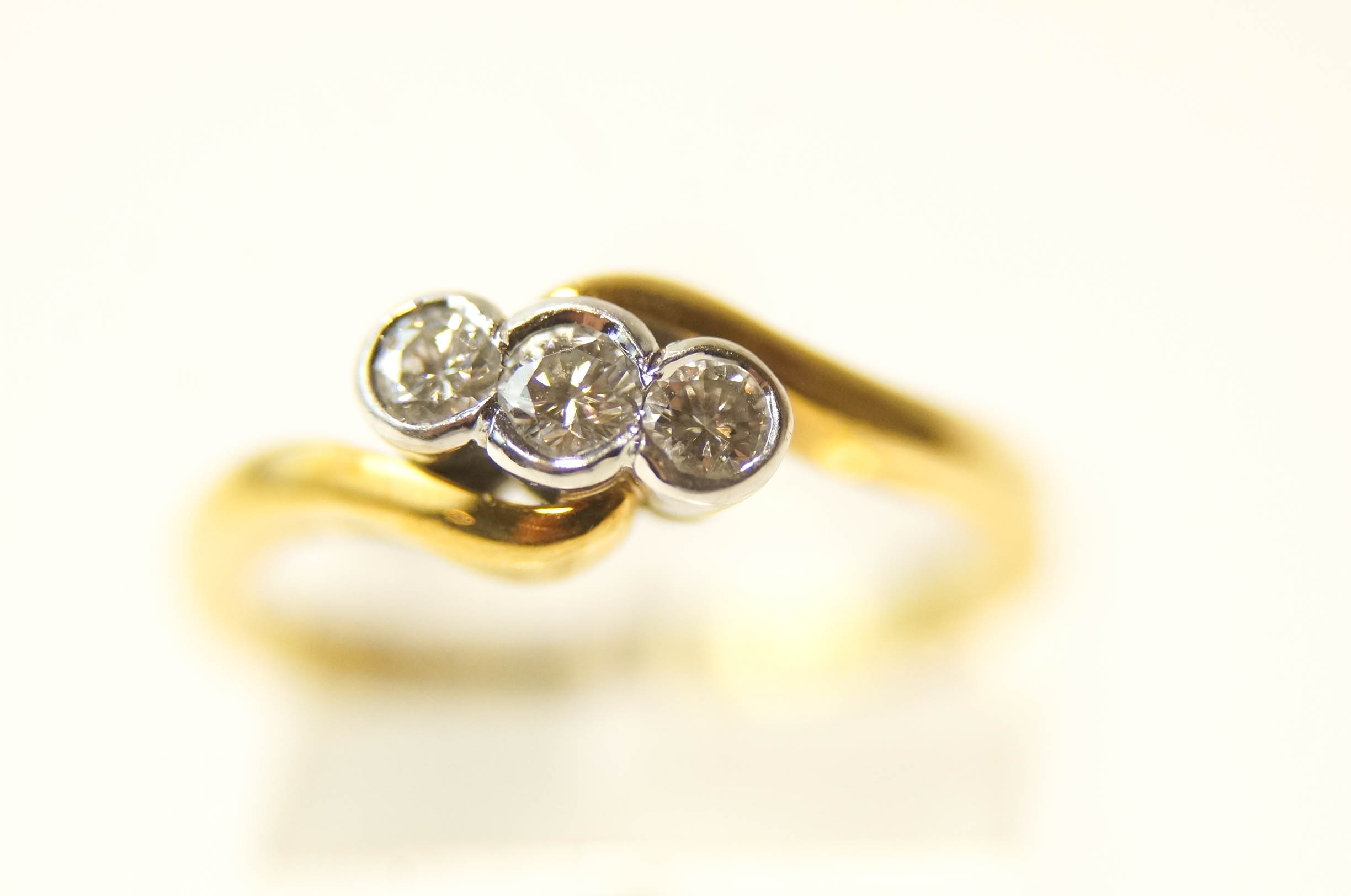 A three stone diamond 18 carat gold crossover ring, - Image 2 of 2