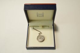 A Silver Sixpence locket, on a chain,