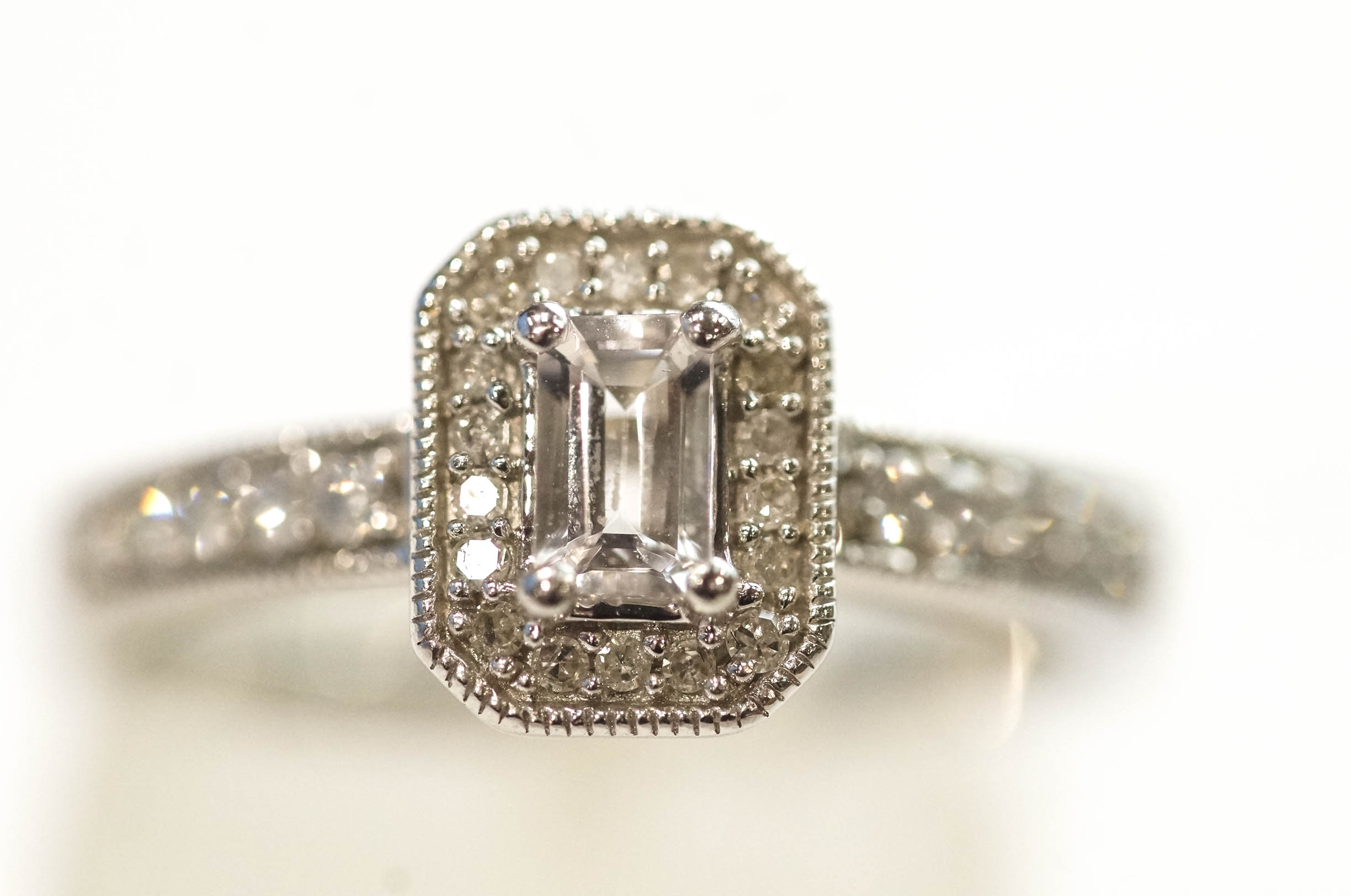 A 9 carat white gold ring set with single cut diamonds around a step cut cubic zirconia, - Image 2 of 2