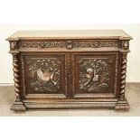 A 19th Century oak sideboard, carved in relief with barley twist sides,