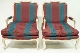 A pair of French style armchairs with limed frames and cabriole legs.