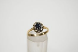 A small sapphire and diamond oval cluster ring,