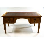 An early 20th century oak writing desk, with tooled leather writing surface,