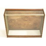 A table top mahogany display case, with open back and sloping glass top,