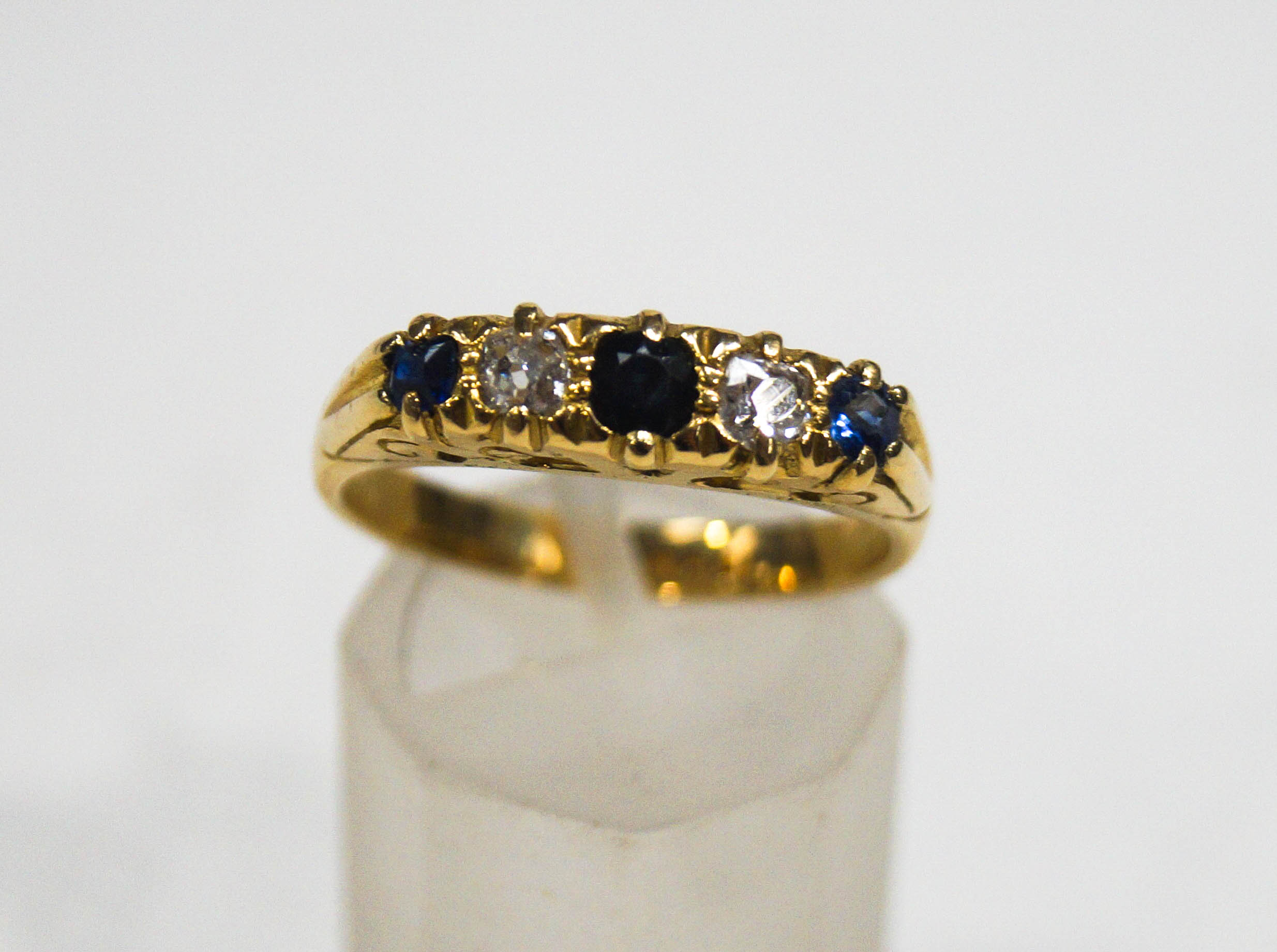 A sapphire and diamond five stone carved half hoop ring, stamped '18ct'. 5. - Image 2 of 2