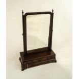 A Georgian mahogany rectangular toilet mirror, with three drawers to the base, upon bracket feet,
