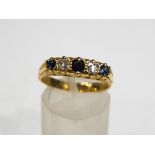 A sapphire and diamond five stone carved half hoop ring, stamped '18ct'. 5.