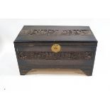 A Chinese hardwood chest, heavily carved with ships, 101cm wide,