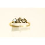 A three stone diamond 18 carat gold ring, the graduated brilliant cuts totalling approximately 0.