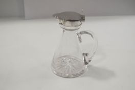 A silver mounted glass whiskey tot, by Heath & Middleton, Birmingham 1906, of usual form,