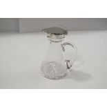 A silver mounted glass whiskey tot, by Heath & Middleton, Birmingham 1906, of usual form,