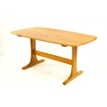 A 20th Century Ercol elm and beech dining table,