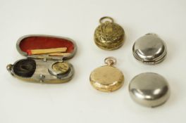 A metal coin case; with two others; an American fob watch in a gilt metal case;