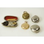 A metal coin case; with two others; an American fob watch in a gilt metal case;