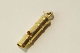 A 9 carat gold whistle, 3.7 cm long, 2.