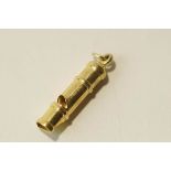 A 9 carat gold whistle, 3.7 cm long, 2.