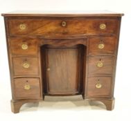 A 19th century mahogany serpentine kneehole desk, fitted with nine drawers and central cupboard,