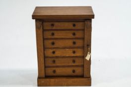 An early 20th Century oak table top collectors cabinet, 48cm high x 37.
