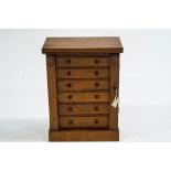 An early 20th Century oak table top collectors cabinet, 48cm high x 37.