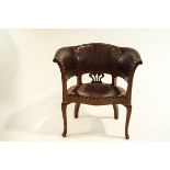 A 20th century tub chair with studded leatherette upholstery