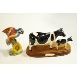 A Beswick Friesian cow and calf, upon a wooden base,