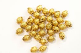 A collection of Indian filled gold beads, from a necklace,