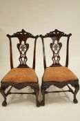 A pair of George II style mahogany dining chairs with carved splat backs,