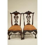 A pair of George II style mahogany dining chairs with carved splat backs,