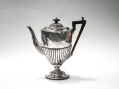 A late Victorian silver oval part fluted pedestal coffee pot with a domed cover with a fluted wood