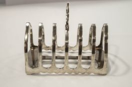 A silver toast rack, by James Dixon & Sons, Sheffield 1929, six division, 11.5 cm long, 128 g (4.