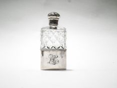 A silver mounted clear cut glass spirit or hip flask,