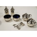 A matched six piece silver Lindisfarne pattern cruet set, by Reid & Son of Newcastle Upon Tyne,