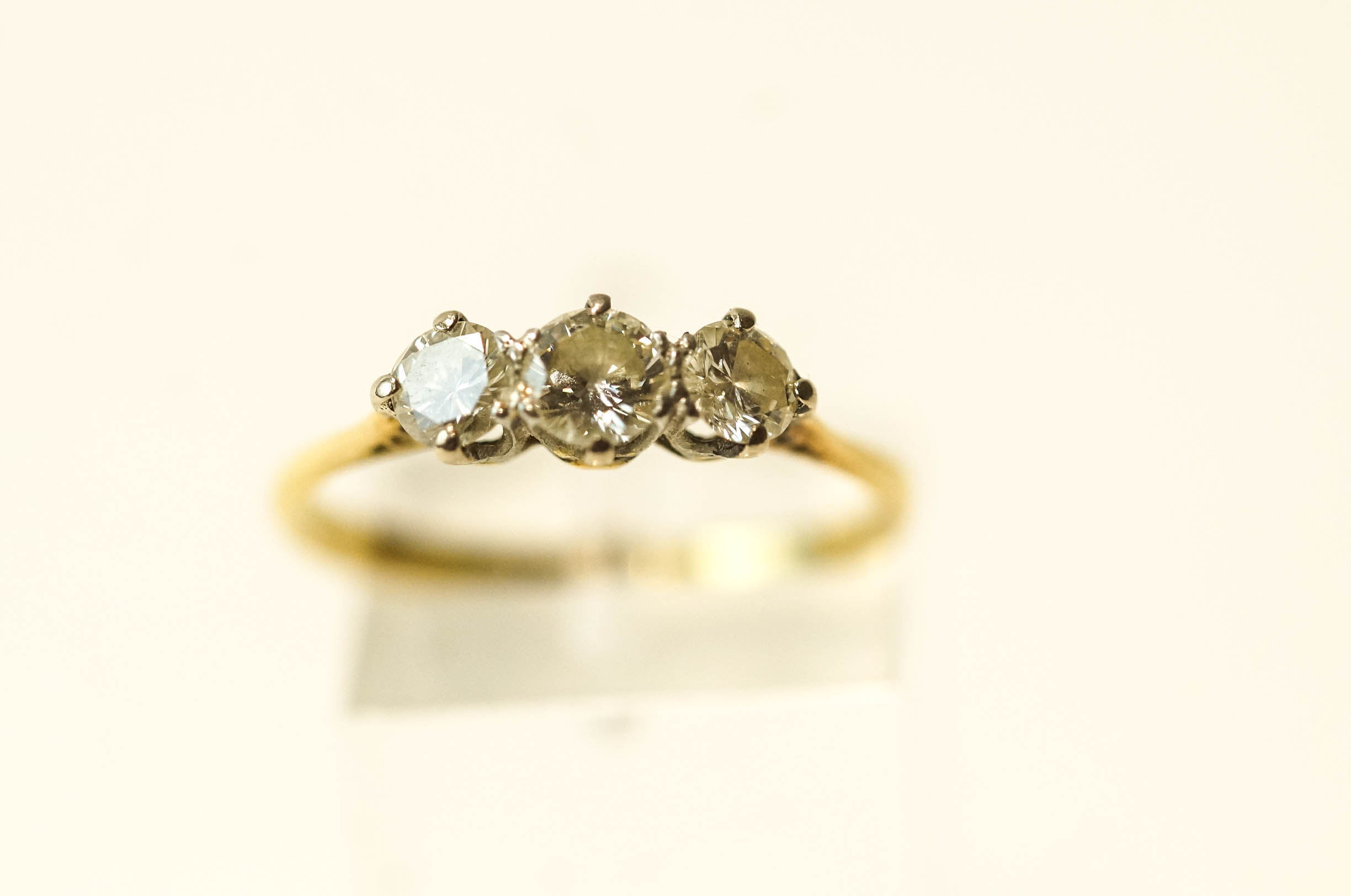 A three stone diamond 18 carat gold ring, the graduated brilliant cuts totalling approximately 0. - Image 2 of 2